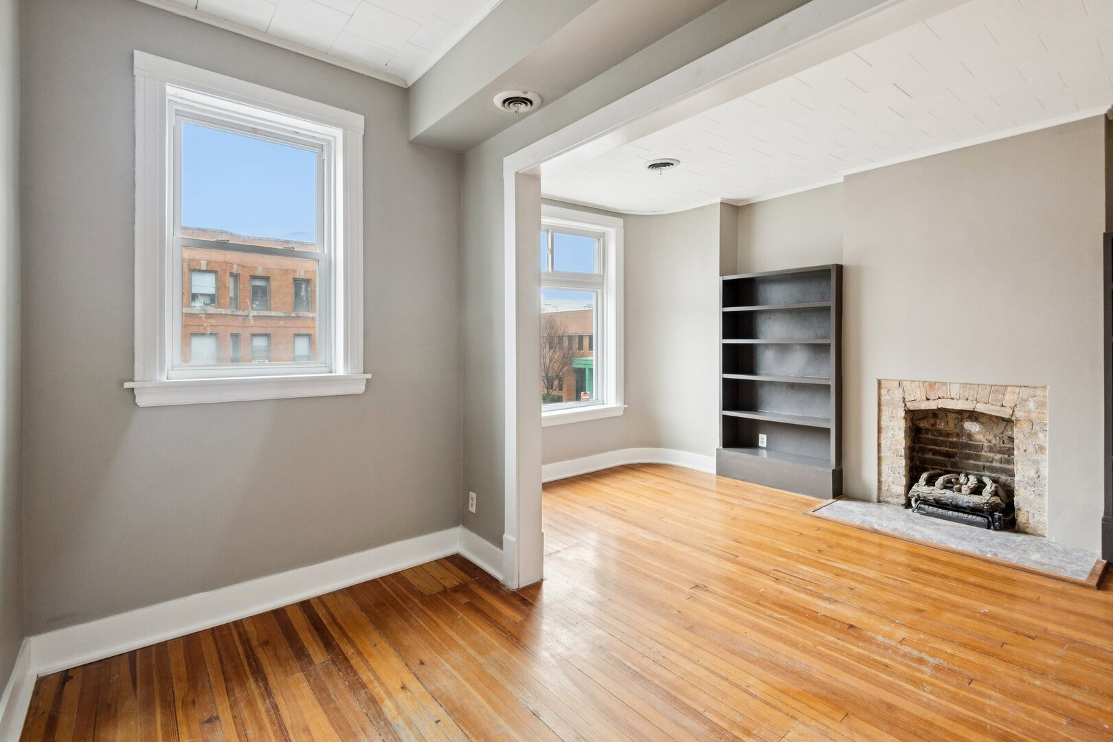 903 West Addison Street, Unit 1 Chicago, IL 60613 - Photo 15 of 25 a view of a livingroom with wooden floor and a fireplace