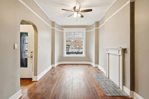 a view of hallway with a large window and wooden floor