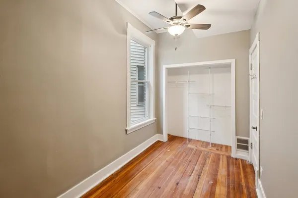 wooden floor in an empty room with a window
