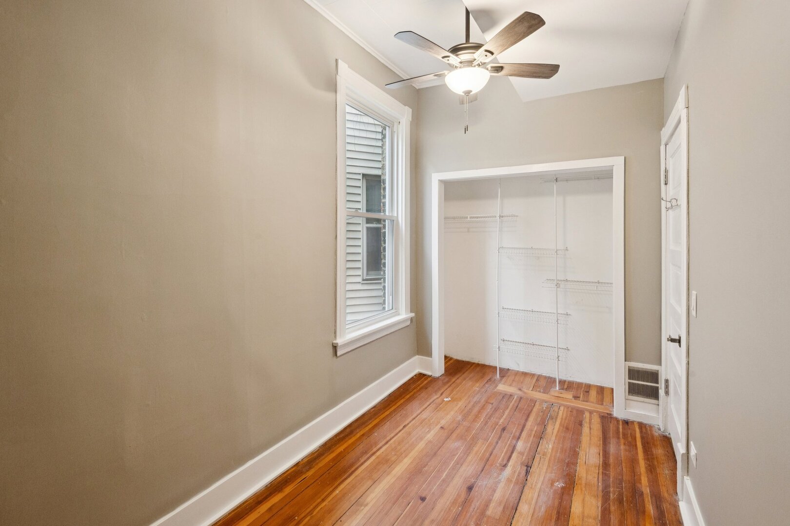 903 West Addison Street, Unit 1 Chicago, IL 60613 - Photo 24 of 25 wooden floor in an empty room with a window