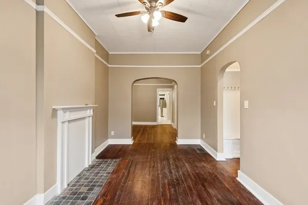 a view of a hallway view with wooden floor and staircase