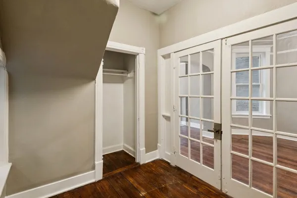 a view of wooden floor and windows in a room