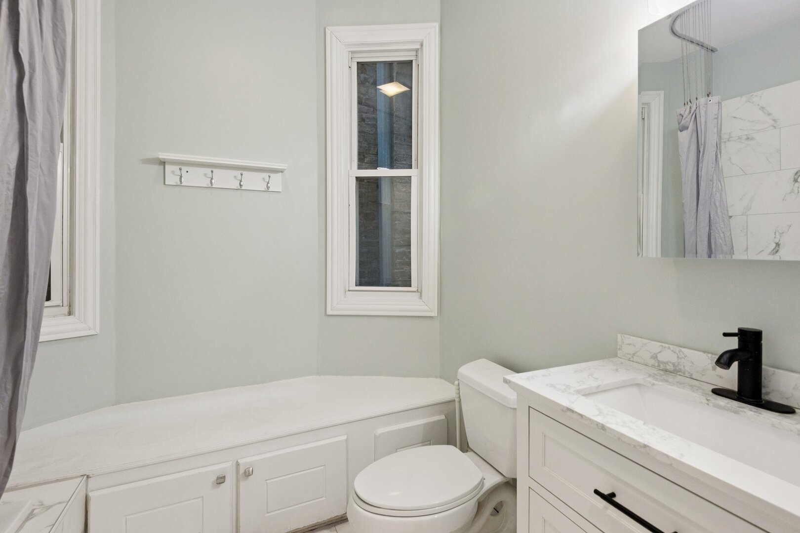 903 West Addison Street, Unit 1 Chicago, IL 60613 - Photo 7 of 25 a bathroom with a sink a toilet and shower