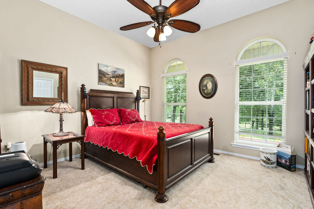 365 Calihan Road Booneville, AR 72927 - Photo 34 of 59 Room featuring vaulted ceilings, carpeted flooring, and two arched windows