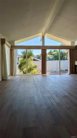 a view of an empty room with a large window