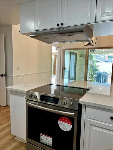 a stove top oven sitting inside of a kitchen