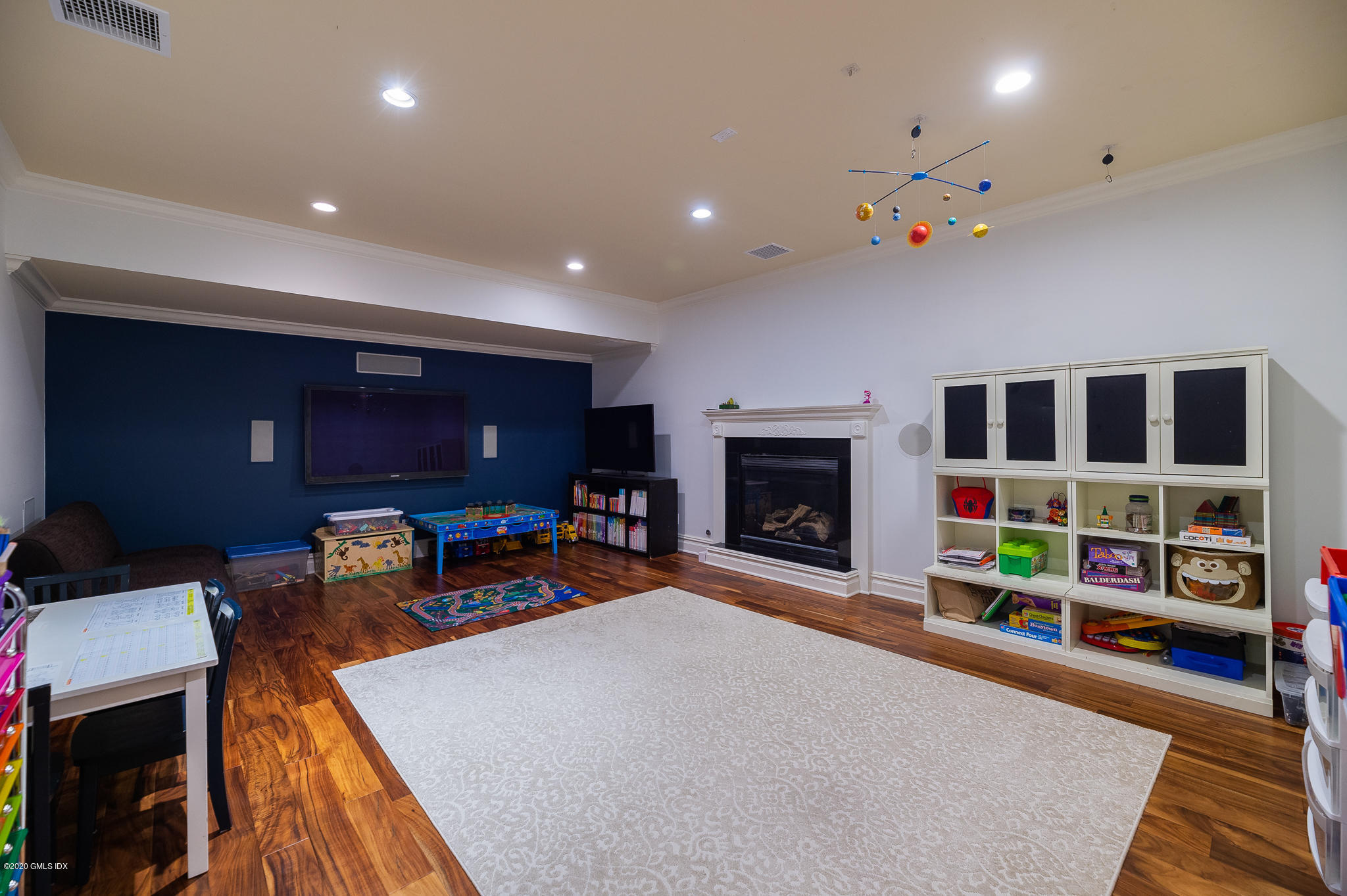 15 Old Orchard Road Riverside, CT 06878 - Photo 19 of 26 a living room with furniture a flat screen tv and a fireplace