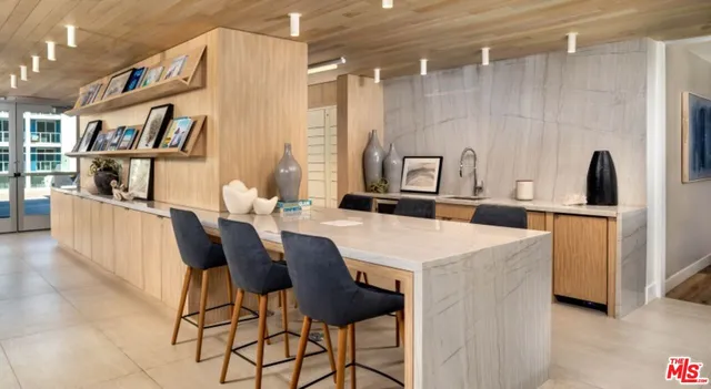 a view of a dining room with furniture and a book shelf