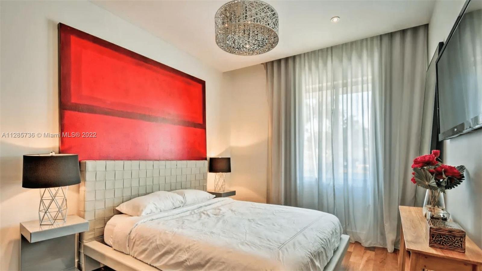 Keystone Point North Miami, FL 33181 - Photo 15 of 26 a bedroom with a bed and a flat screen tv