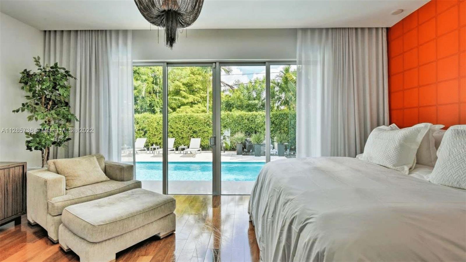 Keystone Point North Miami, FL 33181 - Photo 18 of 26 a bedroom with a bed and a large window