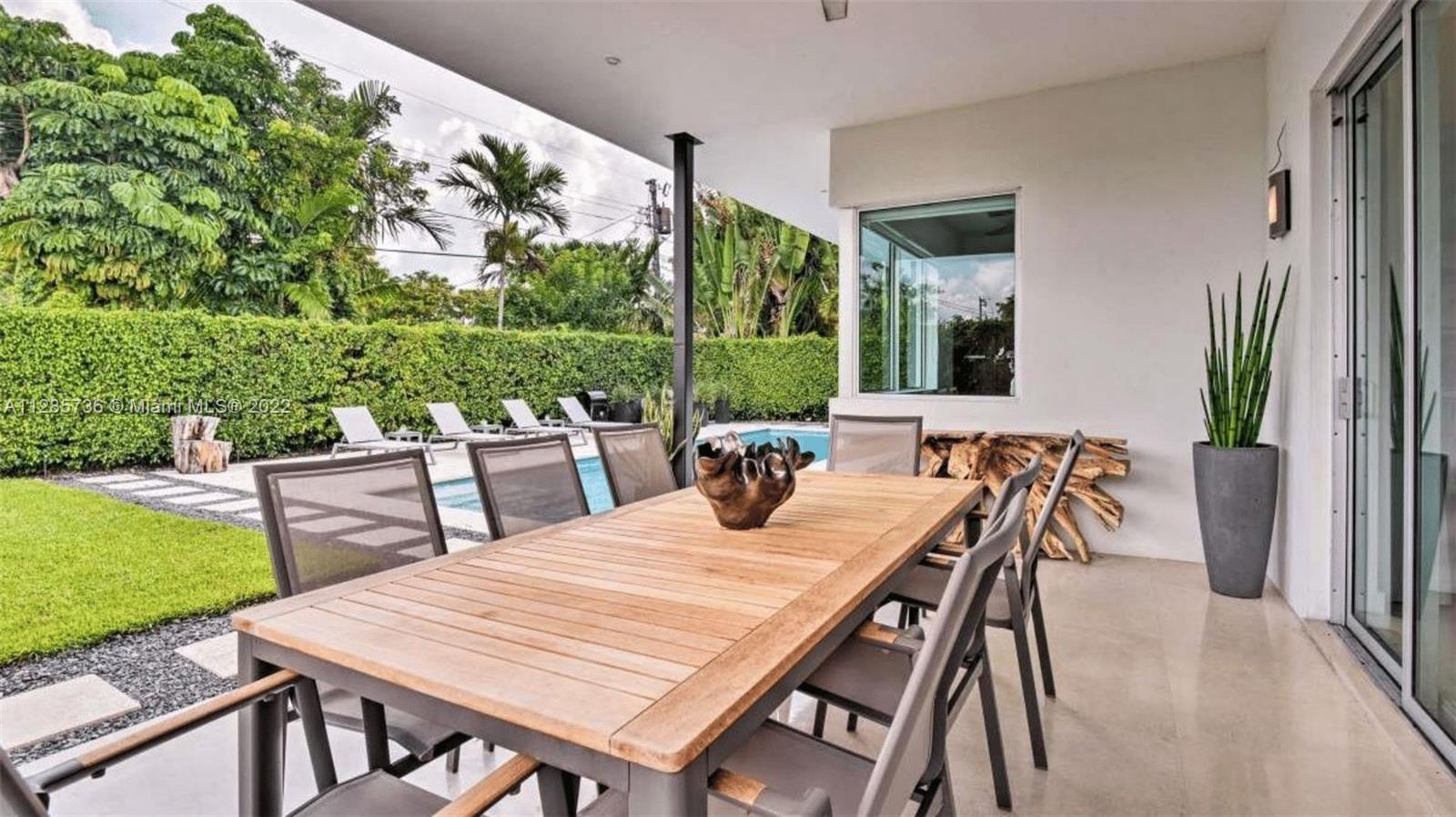 Keystone Point North Miami, FL 33181 - Photo 22 of 26 a outdoor dining space with furniture and garden view