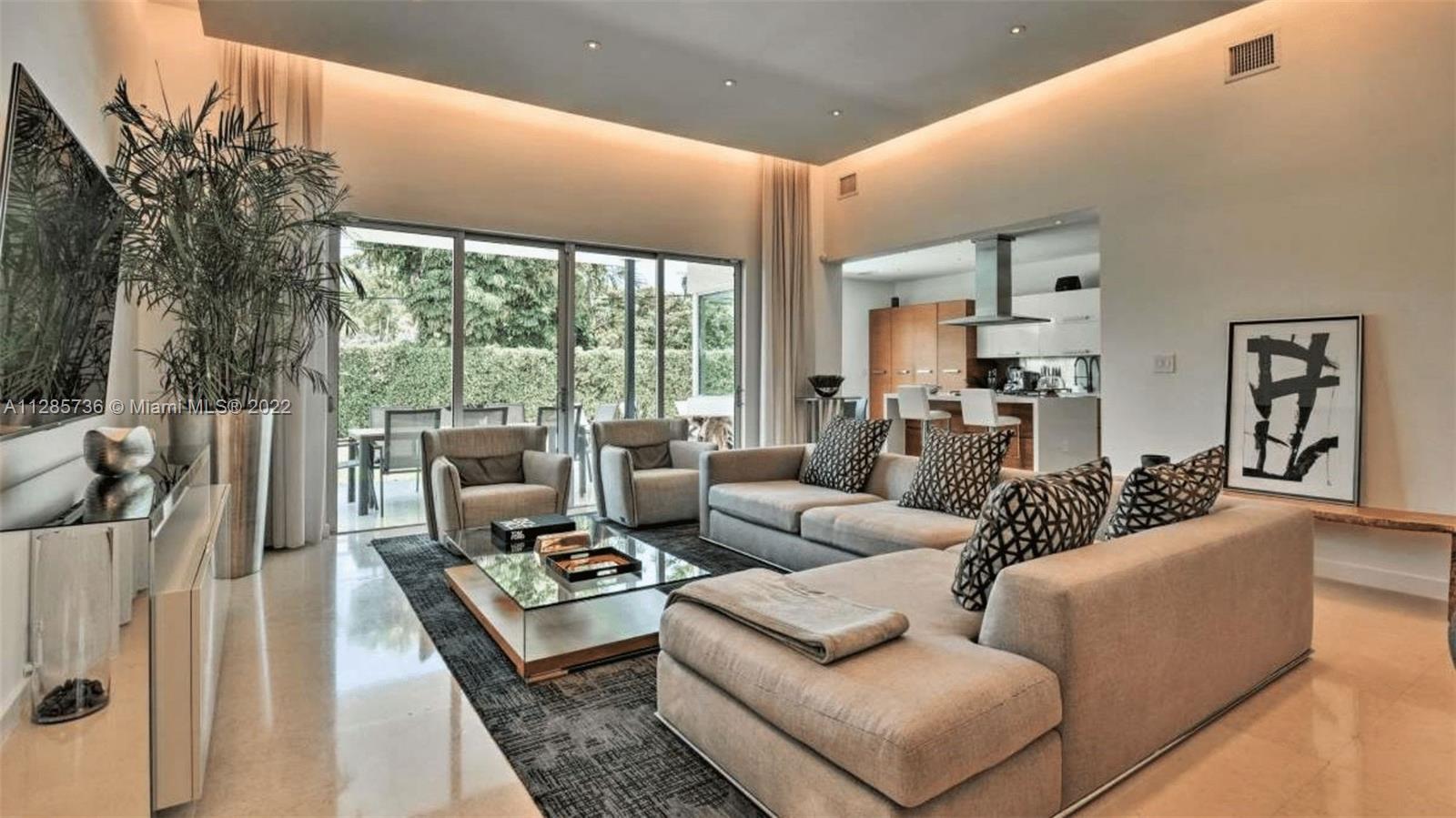 Keystone Point North Miami, FL 33181 - Photo 7 of 26 a living room with furniture floor to ceiling window and a table