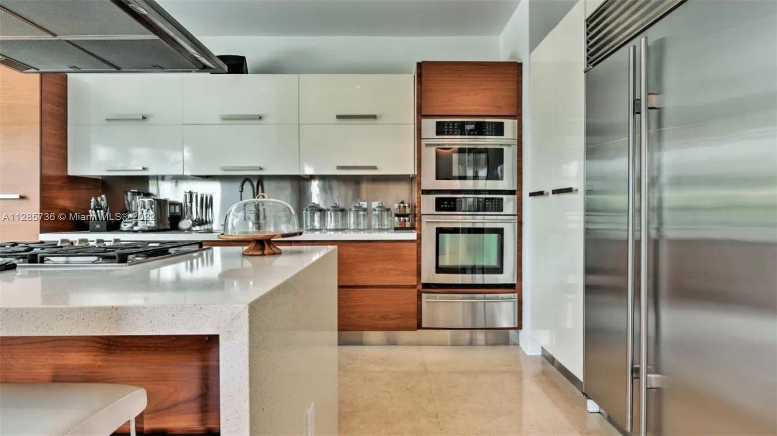 Keystone Point North Miami, FL 33181 - Photo 10 of 26 a kitchen with a refrigerator and a counter top space