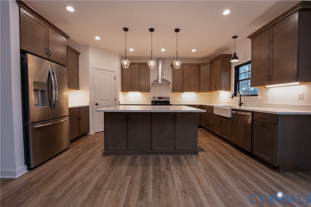 5512 Hickory Ridge Road Spotsylvania, VA 22551 - Photo 5 of 22 a kitchen with kitchen island granite countertop a sink appliances and cabinets
