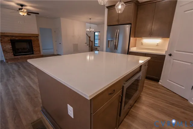 a close view of a refrigerator a stove a sink and dishwasher with wooden floor