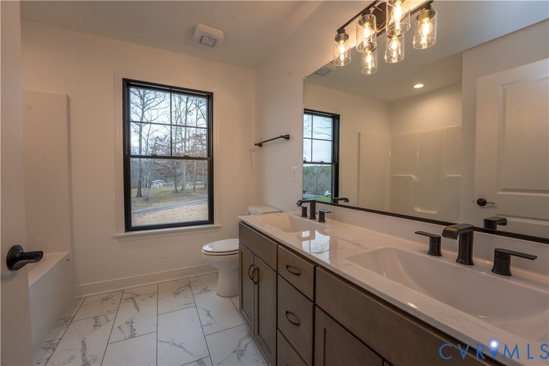 5512 Hickory Ridge Road Spotsylvania, VA 22551 - Photo 10 of 22 a bathroom with a double vanity sink a toilet and a mirror