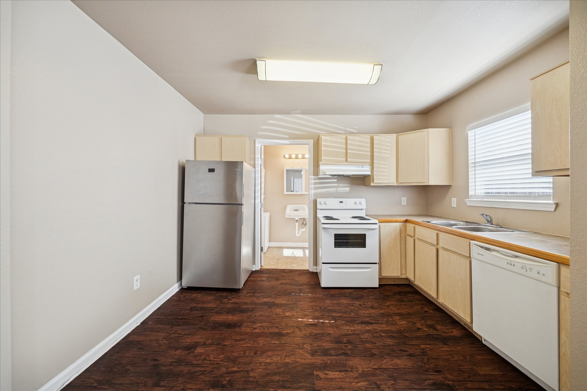 1225 West 25th Street, Unit 9 Houston, TX 77008 - Photo 3 of 11 a kitchen with a refrigerator sink and cabinets