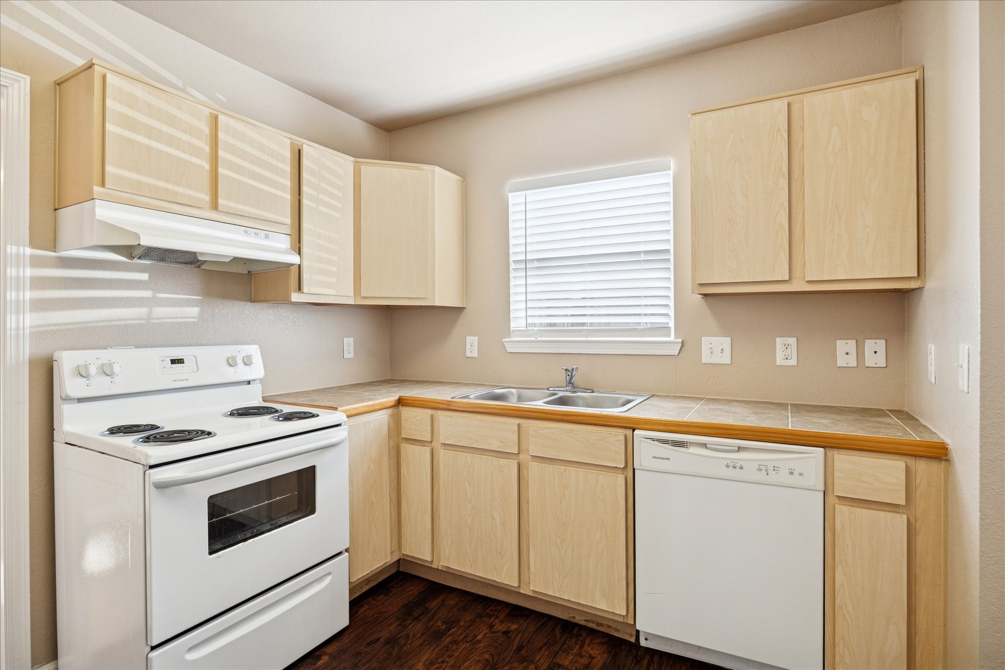 1225 West 25th Street, Unit 9 Houston, TX 77008 - Photo 4 of 11 a kitchen with granite countertop white cabinets and white appliances