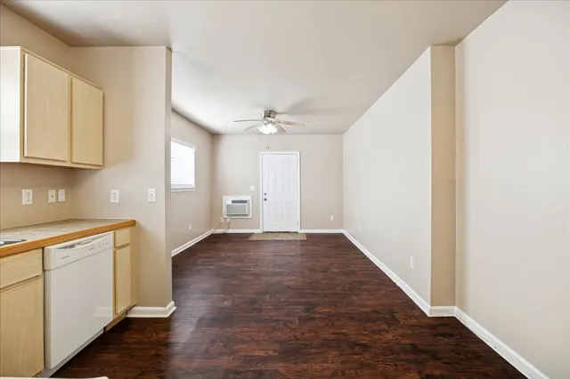 a view of a kitchen with a sink and cabinets