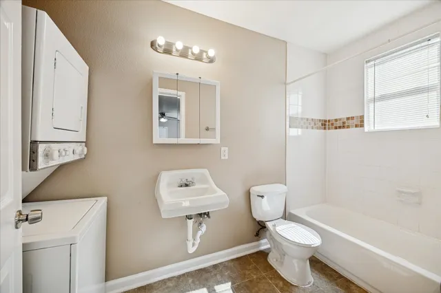 a bathroom with a toilet a sink and a mirror