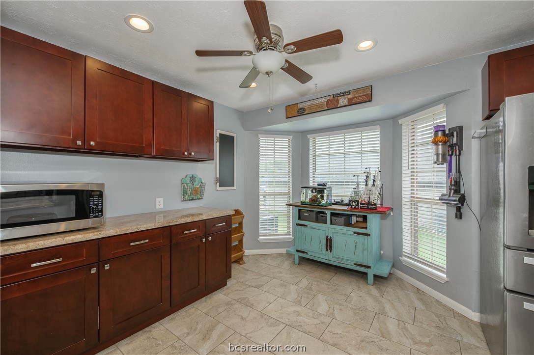 2009 Cobblestone Lane Bryan, TX 77807 - Photo 10 of 23 a kitchen with stainless steel appliances granite countertop a refrigerator and a stove