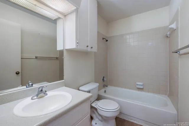 a bathroom with a sink toilet and bathtub