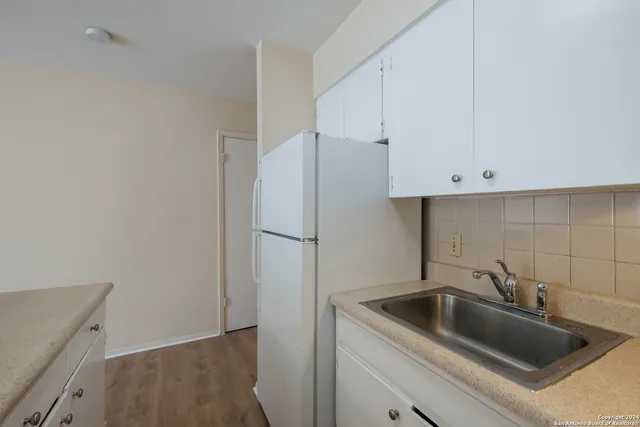 a kitchen with a sink and cabinets