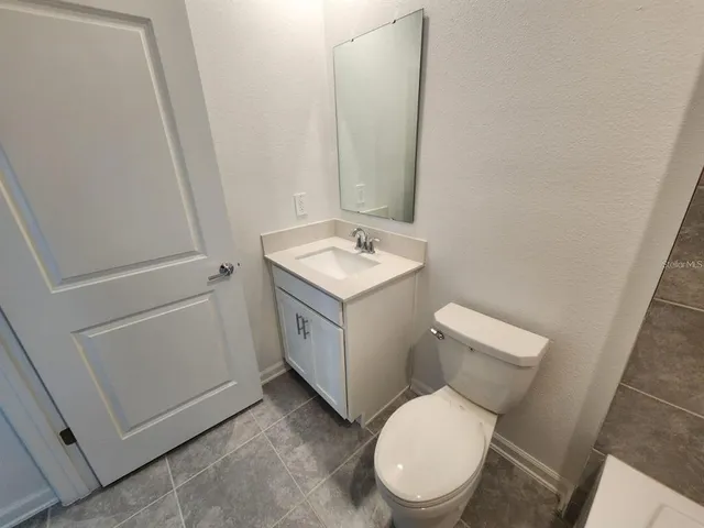 a white toilet sitting next to a bathroom sink