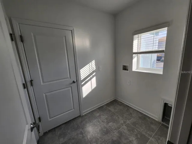 an empty room with windows and closet