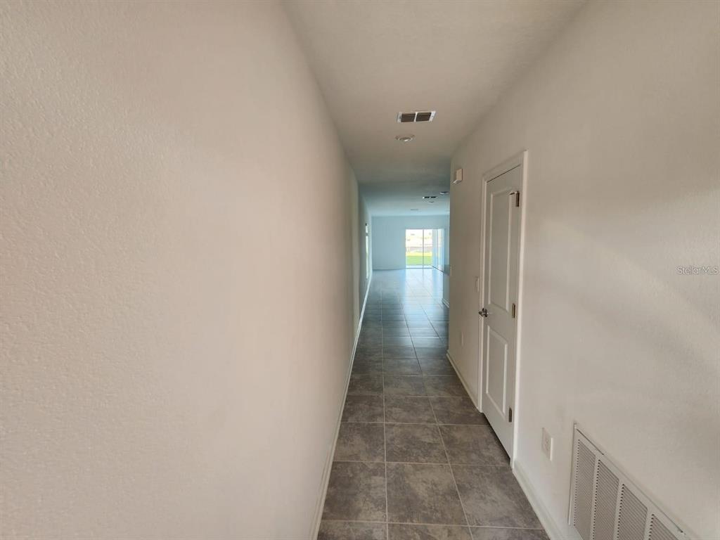 2713 Runners Circle Clermont, FL 34714 - Photo 26 of 30 a view of a hallway with a wooden floor
