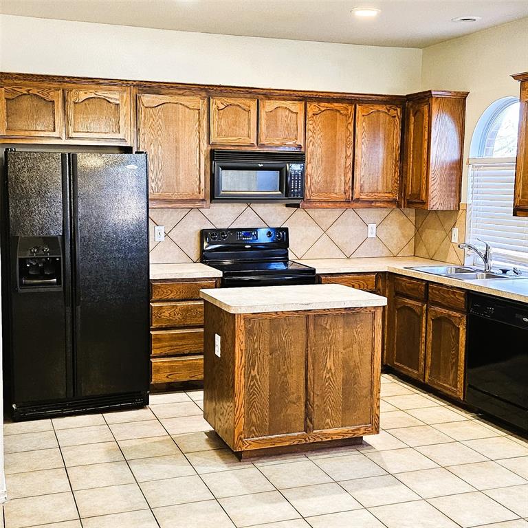7909 Raton Ridge Lane Arlington, TX 76002 - Photo 2 of 10 a kitchen with stainless steel appliances granite countertop a stove a refrigerator and a sink