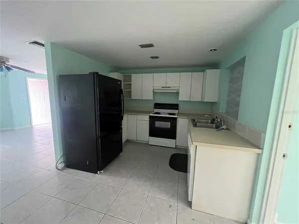 a kitchen with a refrigerator sink and microwave