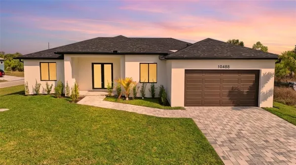a front view of a house with a yard and garage
