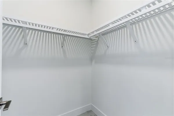 an empty room with a ceiling fan and window