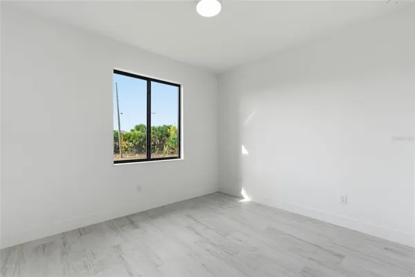 a view of a patio with a table and chairs under an umbrella