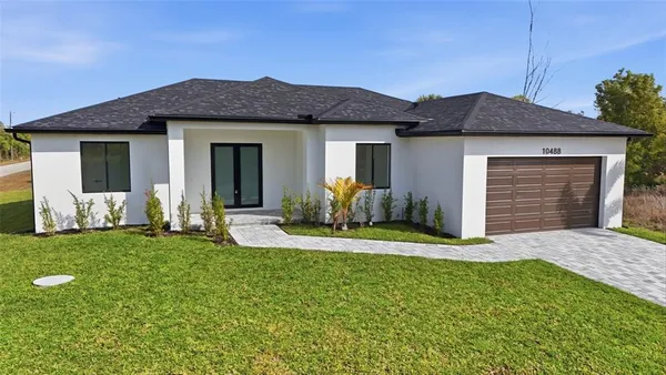 a front view of a house with a yard and garage
