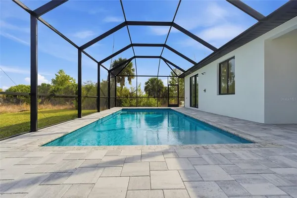 an aerial view of a house with a swimming pool outdoor seating and yard