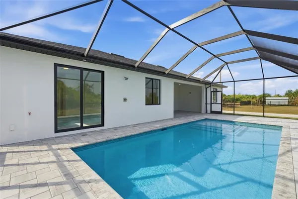 an aerial view of a house with a yard swimming pool outdoor seating and yard