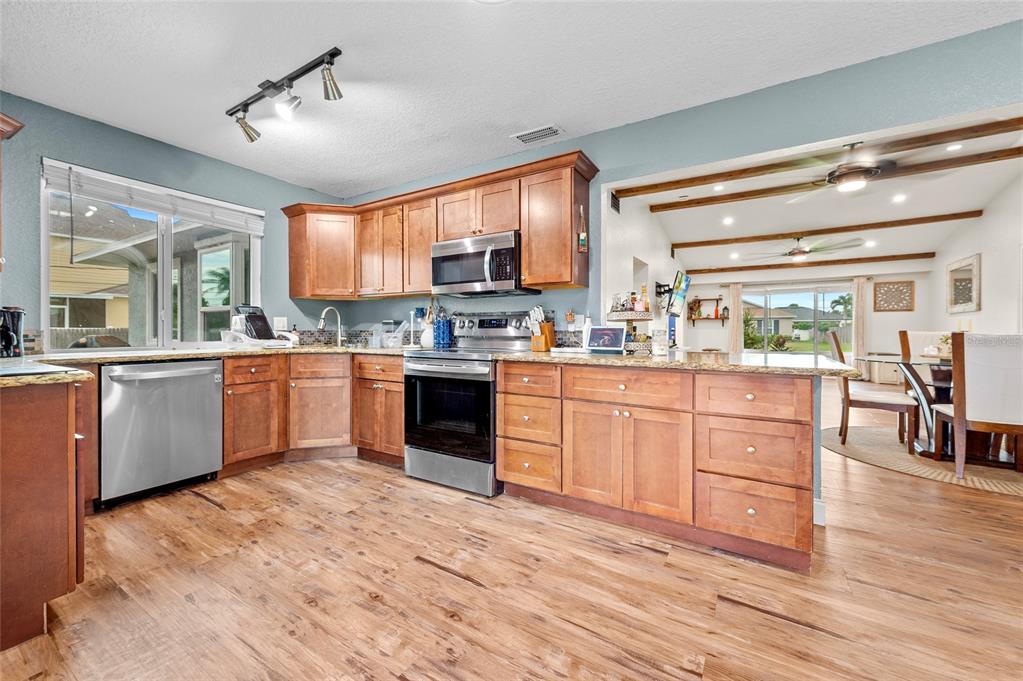 1041 Southwest General Patton Terrace Port St. Lucie, FL 34953 - Photo 12 of 39 a kitchen with a sink window and cabinets