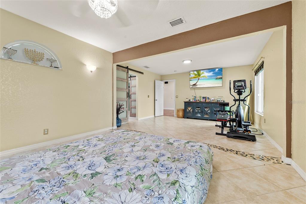1041 Southwest General Patton Terrace Port St. Lucie, FL 34953 - Photo 16 of 39 a view of a bedroom with a bed and cabinets