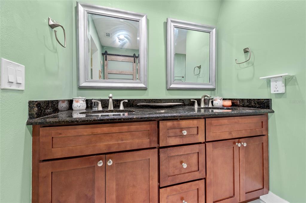 1041 Southwest General Patton Terrace Port St. Lucie, FL 34953 - Photo 24 of 39 a bathroom with a sink and a mirror