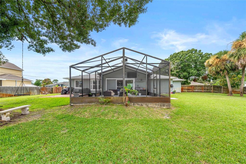 1041 Southwest General Patton Terrace Port St. Lucie, FL 34953 - Photo 27 of 39 a view of a house with a big yard potted plants and large tree