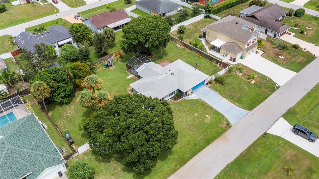 1041 Southwest General Patton Terrace Port St. Lucie, FL 34953 - Photo 34 of 39 an aerial view of a house with a garden and swimming pool