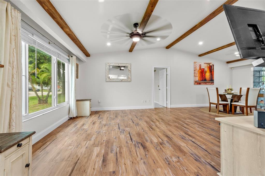 1041 Southwest General Patton Terrace Port St. Lucie, FL 34953 - Photo 4 of 39 a view of empty room with wooden floor and fan