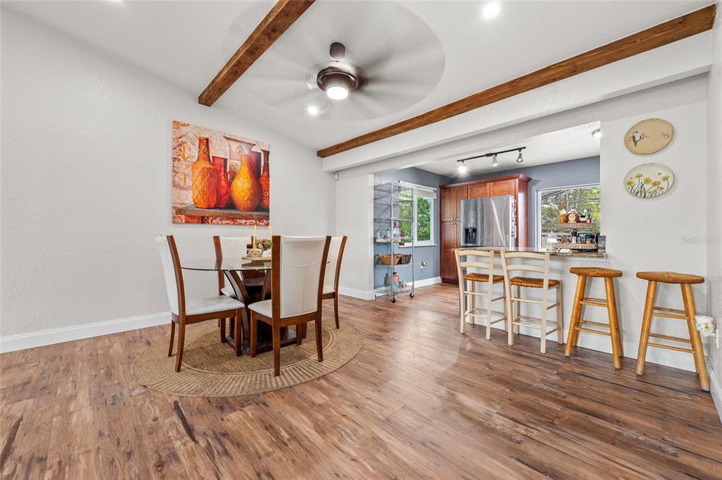 1041 Southwest General Patton Terrace Port St. Lucie, FL 34953 - Photo 7 of 39 a view of a dining room with furniture and wooden floor
