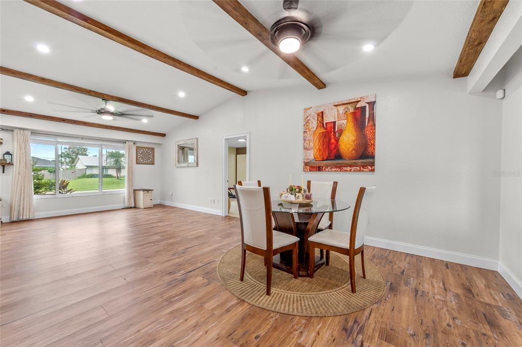 1041 Southwest General Patton Terrace Port St. Lucie, FL 34953 - Photo 8 of 39 a view of a dining room with furniture window and wooden floor