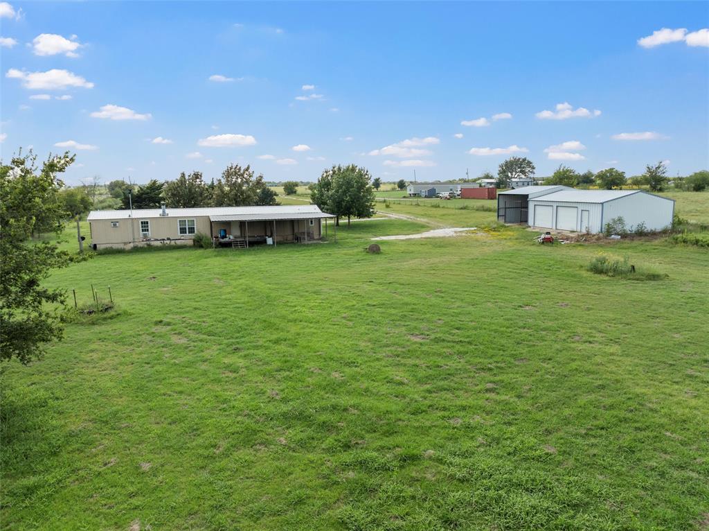 379 Neighbors Corner Road Mart, TX 76664 - Photo 8 of 15 a front view of a house with a garden