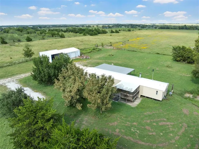 a view of a garden with lawn chairs