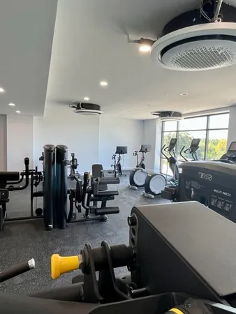 a gym room with lots of chairs and mirrors