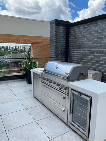 a view of a patio with couches and potted plants